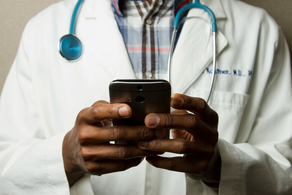 Doctor scrolling on a mobile phone